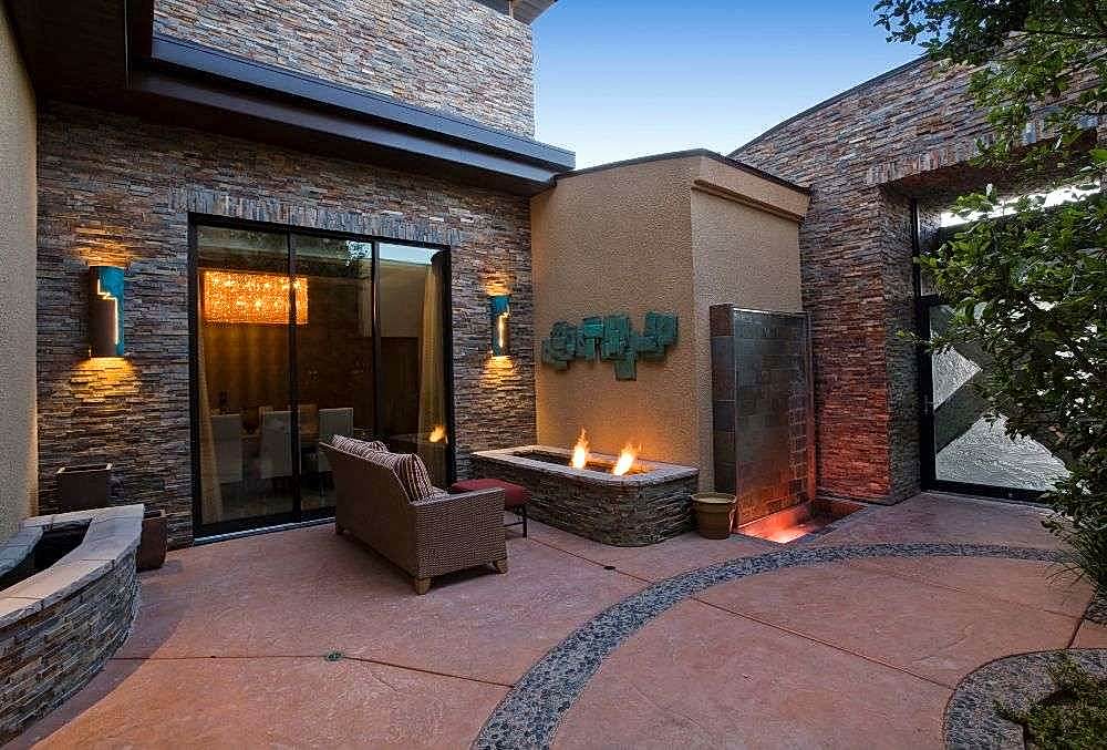 concrete patio with cozy chair and a warm colored flooring