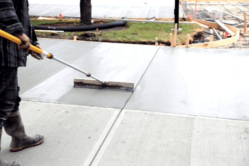 Smoothing And Finishing The New Concrete Driveway