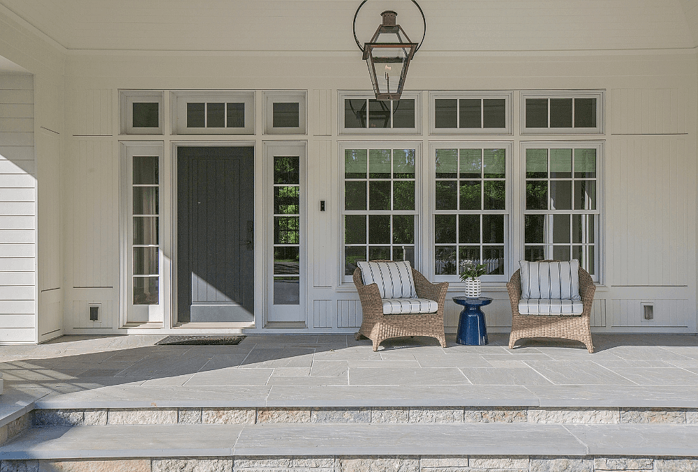 Concrete entryway leading to a modern home's front entrance.