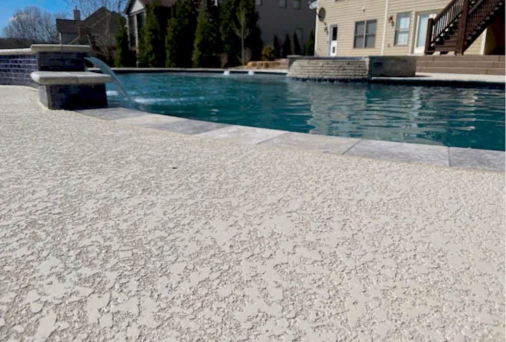 spray knockdown finish on a concrete pool deck